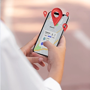 Person holding a smartphone with a digital map and red location pins, showing AI-powered navigation for local SEO services.