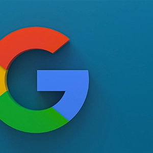 Google’s red, yellow, green, and blue colors on a blue background, slightly left, suggest creative website and SEO solutions.